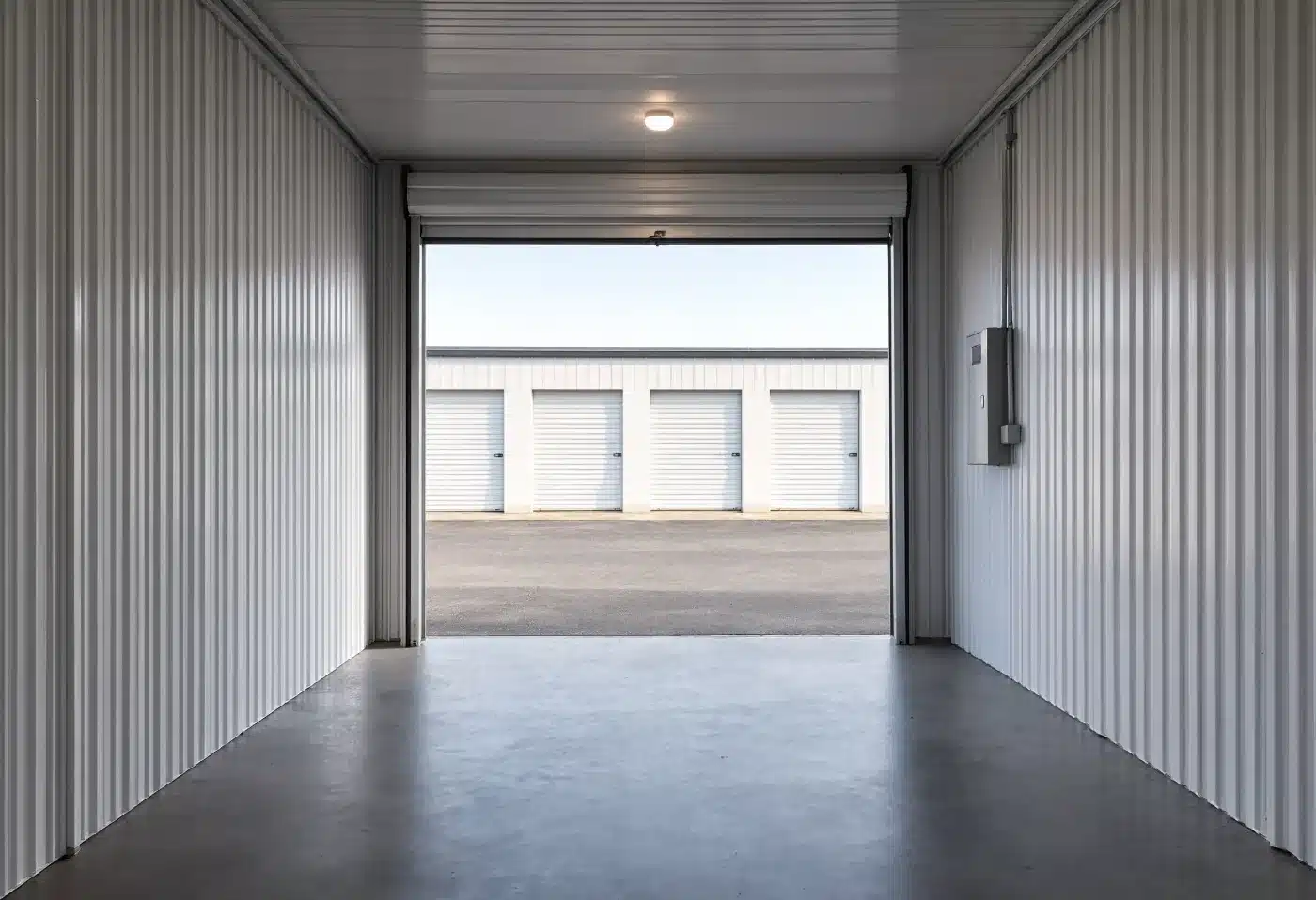 The interior of an empty storage condominium bay looking out to the drive aisle